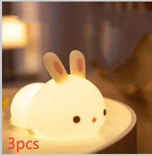 Rabbit silicone pat night light with seven-colour LED on a study desk
