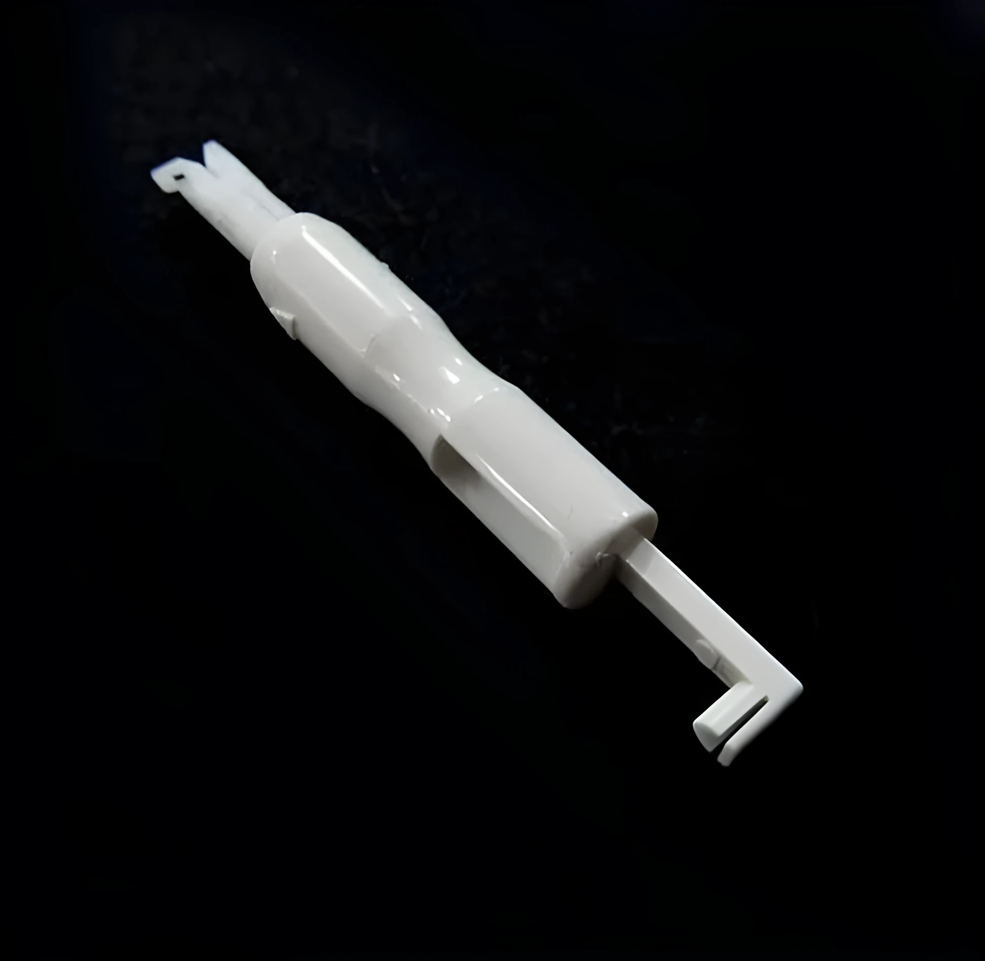 Needle threader insertion tool for sewing machine, plastic and metal, 7.2cm length, shown on white background
