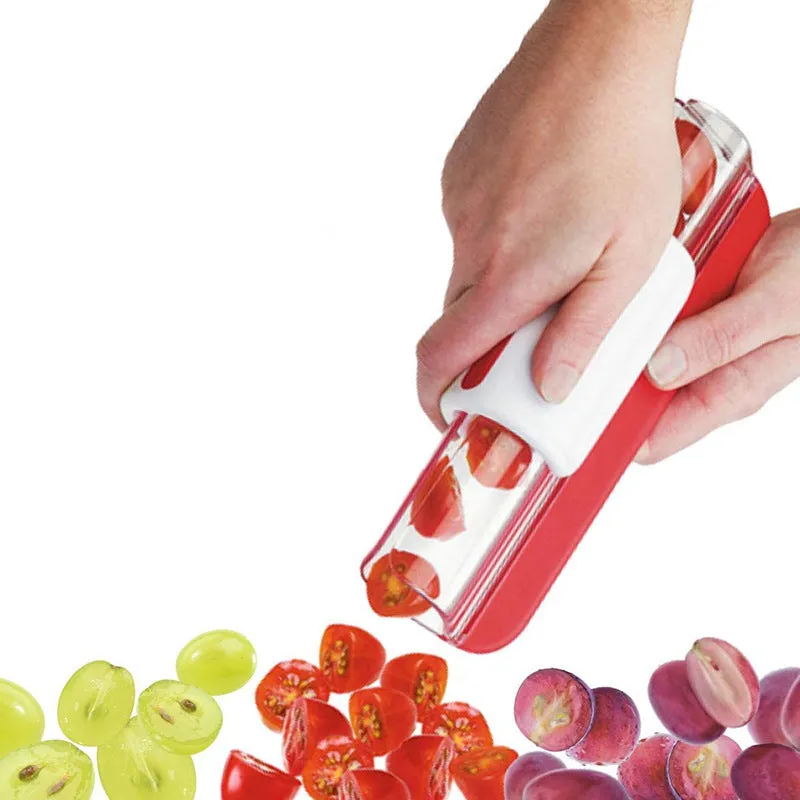 Handheld tomato and grape slicer in green with concealed stainless steel blade on a white background