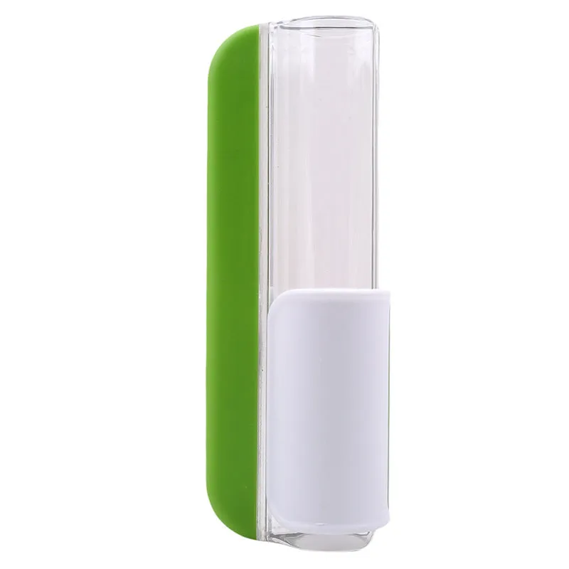 Handheld tomato and grape slicer in green with concealed stainless steel blade on a white background