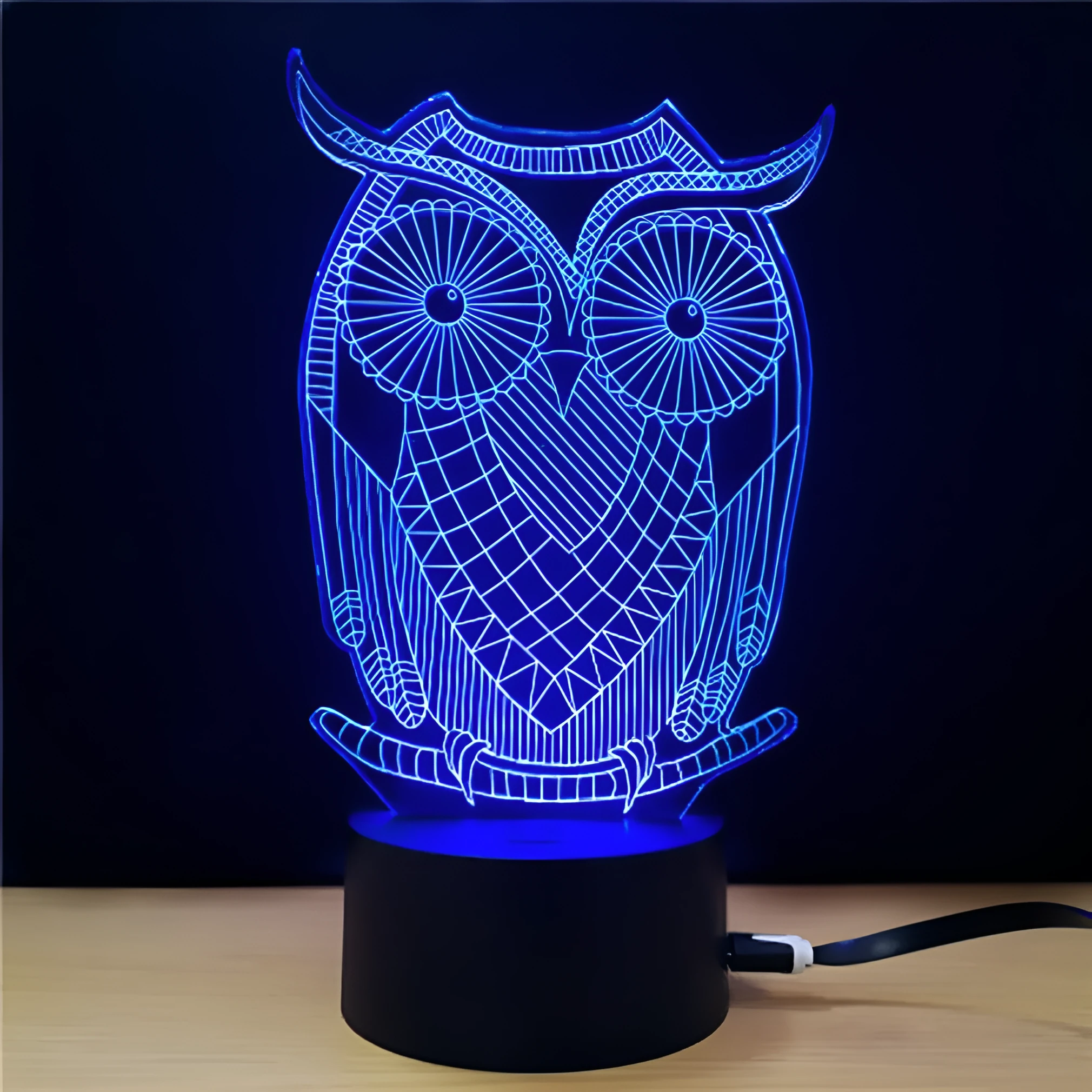 Black LED owl cartoon night light with colourful touch-switch and acrylic shade on a table