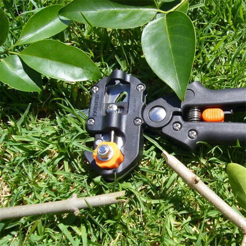 Handheld grafting scissors with black ABS handle and high carbon steel blade cutting a branch