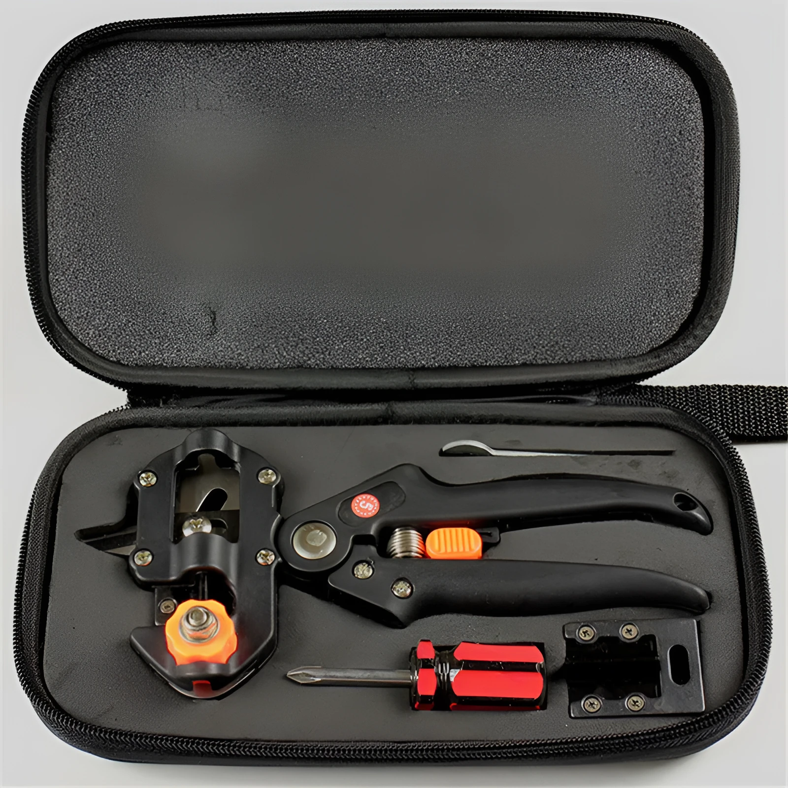 Handheld grafting scissors with black ABS handle and high carbon steel blade cutting a branch