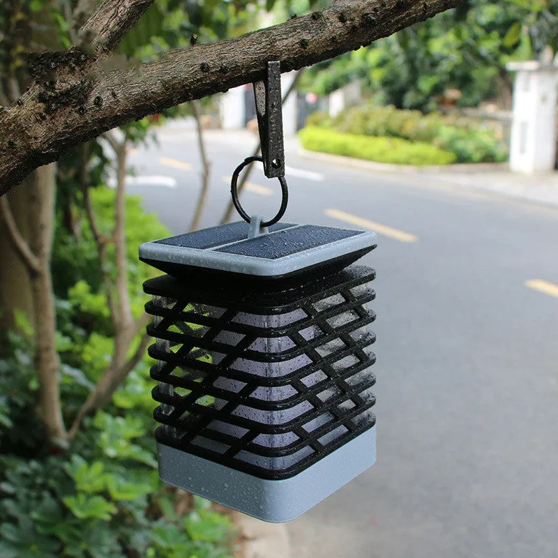 Solar candle flame lawn lamp with 75 yellow LEDs, IP55 rating, placed in a garden setting