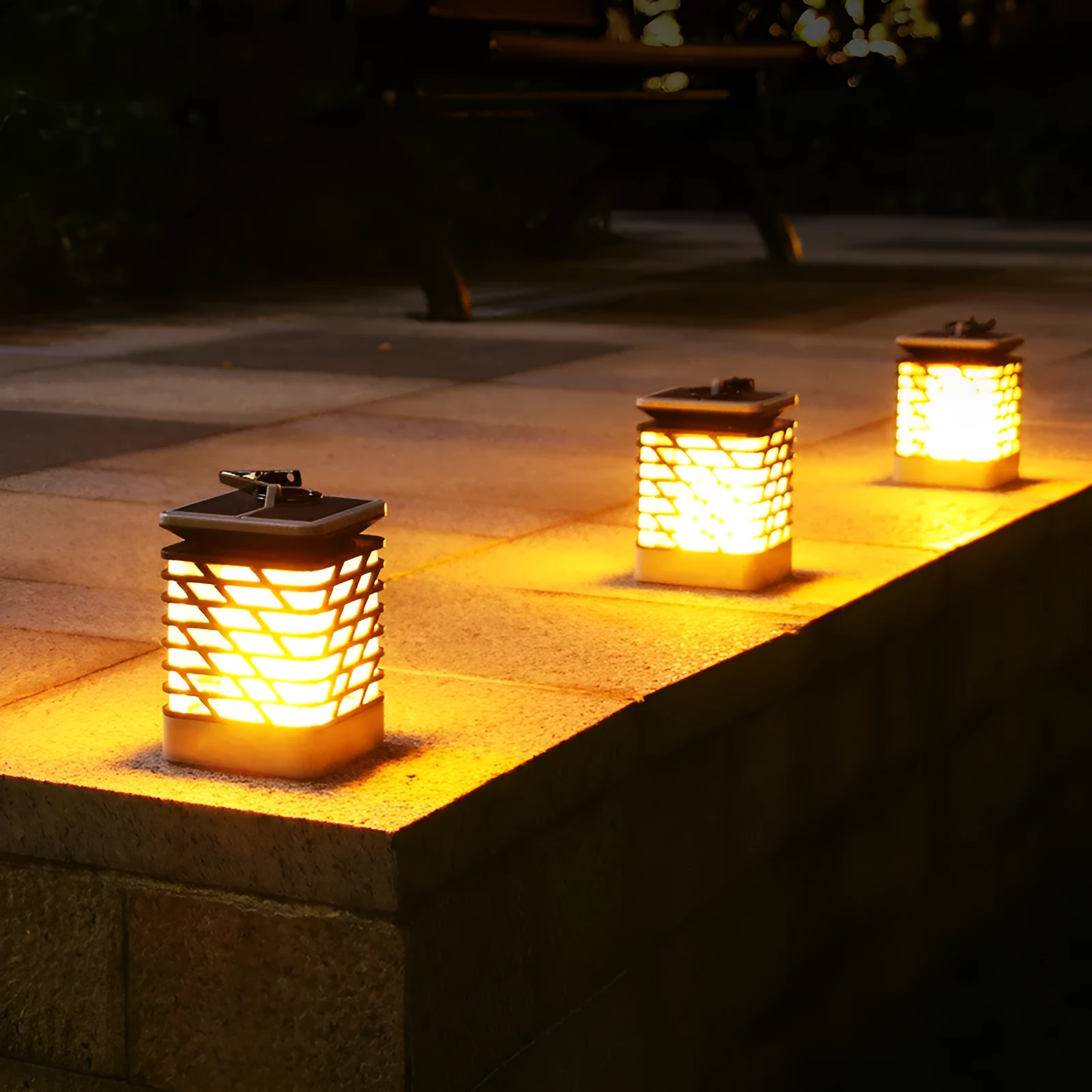 Solar candle flame lawn lamp with 75 yellow LEDs, IP55 rating, placed in a garden setting