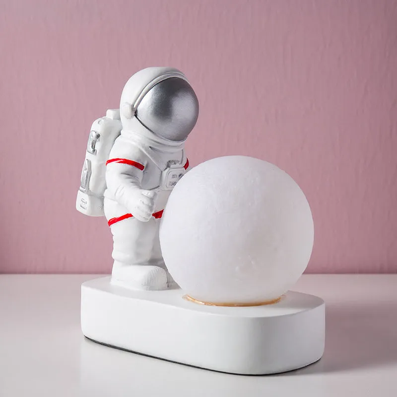 Gold resin astronaut night light on shelf, 14.5cm tall figurine with soft glow