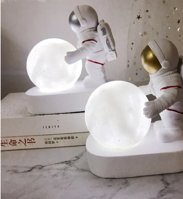 Gold resin astronaut night light on shelf, 14.5cm tall figurine with soft glow