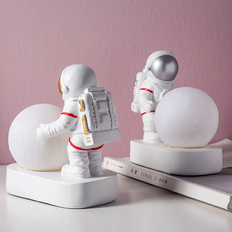 Gold resin astronaut night light on shelf, 14.5cm tall figurine with soft glow