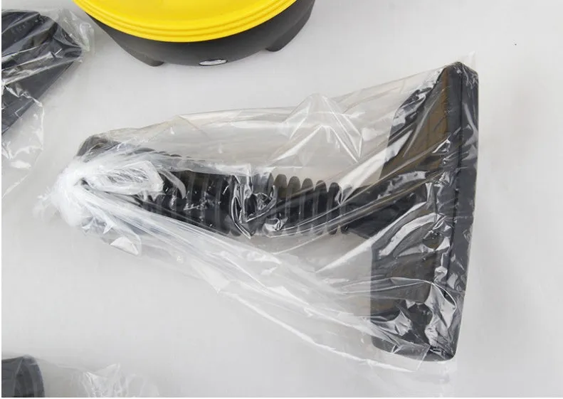 Yellow handheld steam cleaner with 450ml liner on a kitchen surface, 26x21cm size