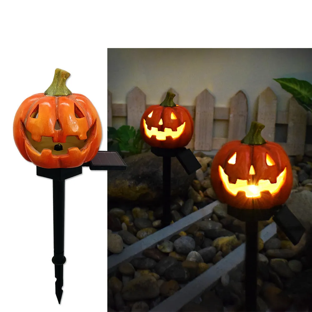 Solar Halloween pumpkin lantern with wizard pumpkin style on a garden path, wrought iron frame