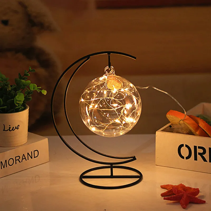 Round glass LED wishing bottle 12 cm with cork, 20 warm white lights, and folded star paper strips on a table