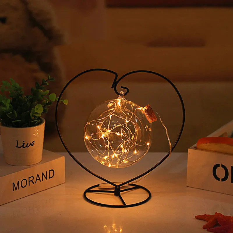 Round glass LED wishing bottle 12 cm with cork, 20 warm white lights, and folded star paper strips on a table