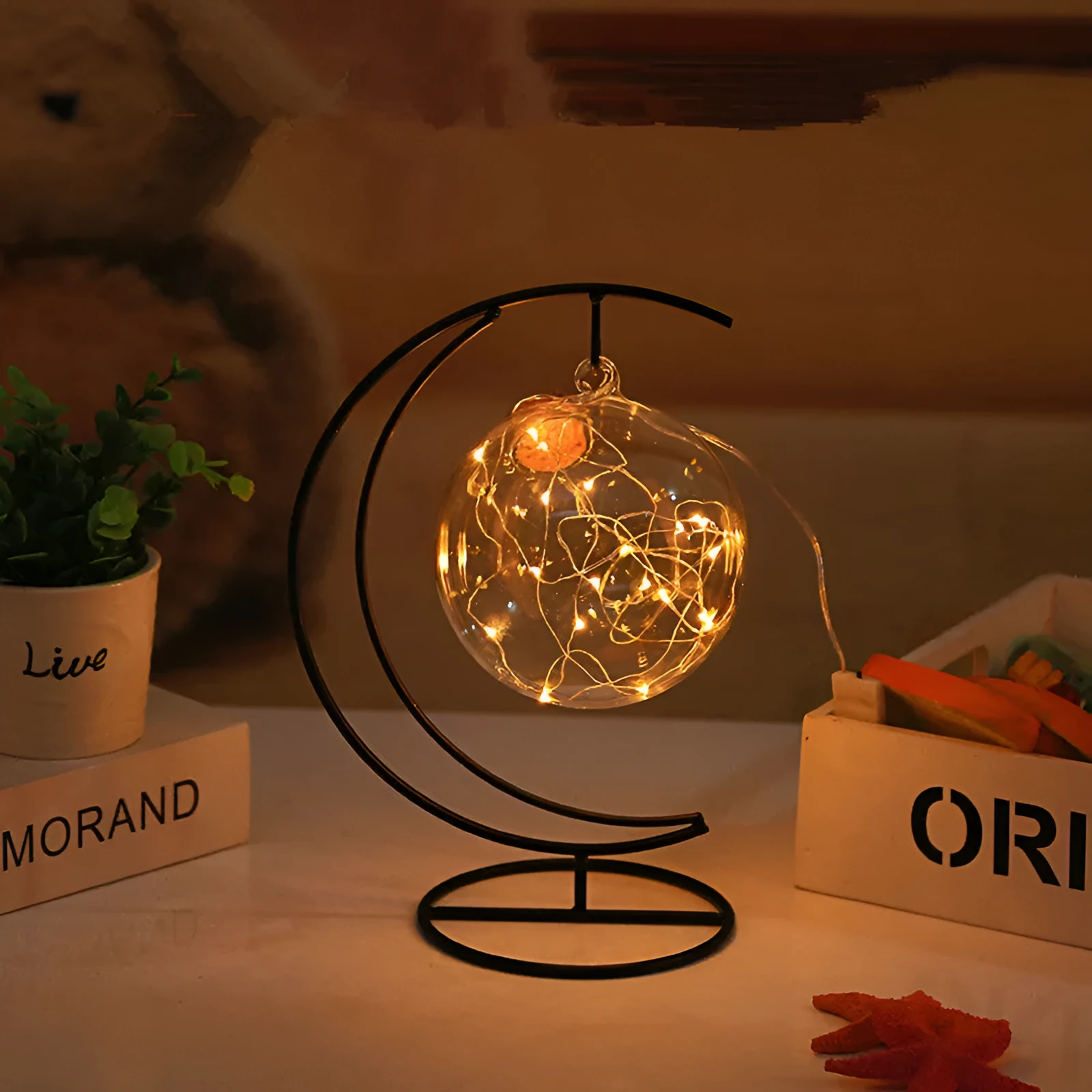 Round glass LED wishing bottle 12 cm with cork, 20 warm white lights, and folded star paper strips on a table