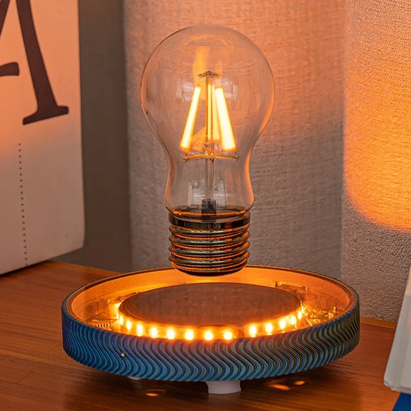 Small magnetic suspension night lamp in a 3D-printed moon design on a dark surface.