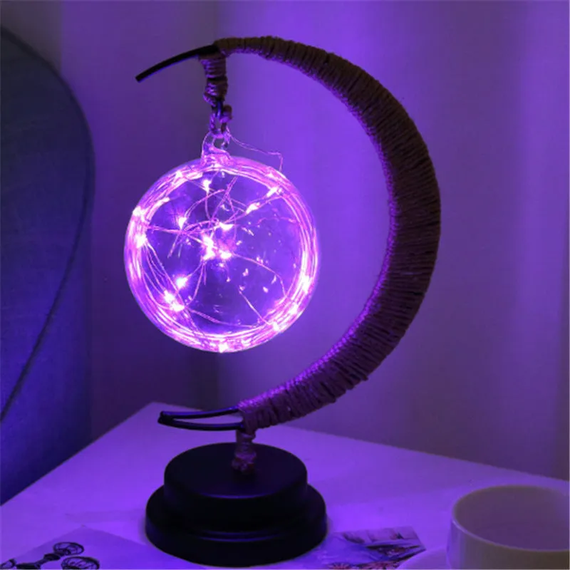 Warm white dimmable LED modelling light in apple shape with 10 beads on a wooden table