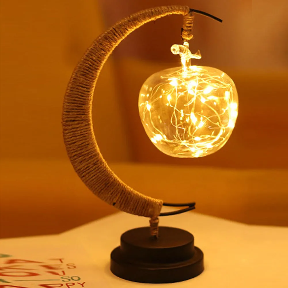 Warm white dimmable LED modelling light in apple shape with 10 beads on a wooden table