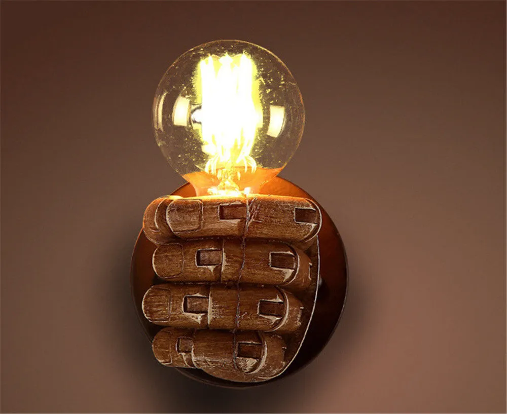 Brown resin fist-shaped decorative wall lamp with E27 bulb holder on a wall
