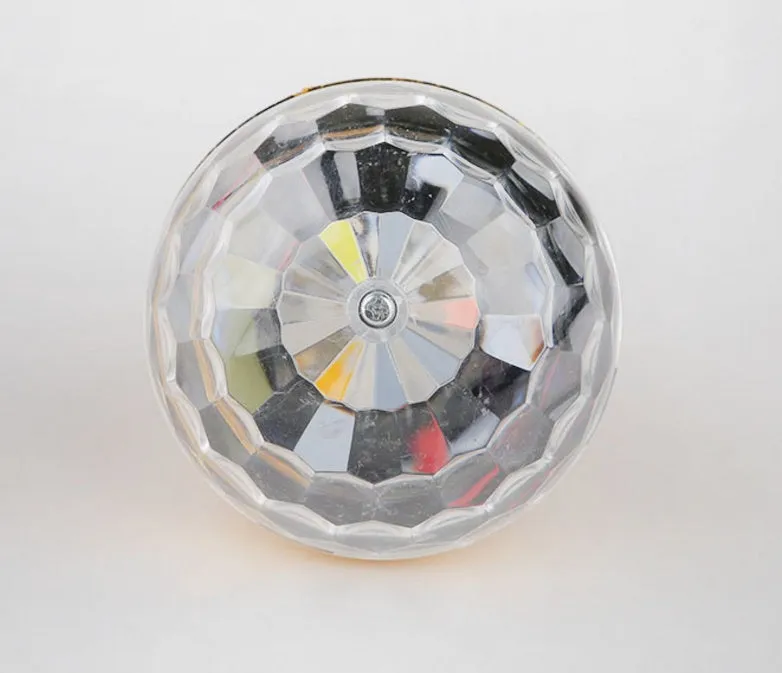 LED colourful rotating magic ball light with 6 RGB beads and lamp holder on a table