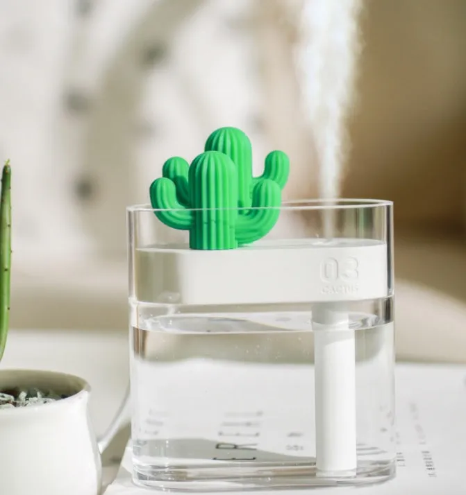 Transparent green cactus USB portable humidifier on desk showing water level inside plastic body