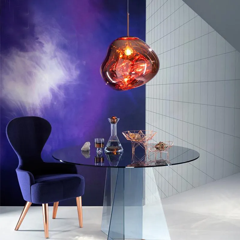 A modern irregular shaped glass chandelier with a Nordic design in a gold finish, hanging from a ceiling.