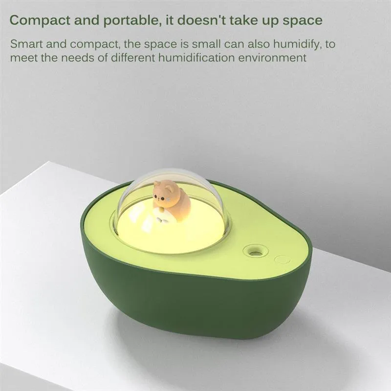 Green avocado-shaped mini humidifier with USB cable and night light on a desk