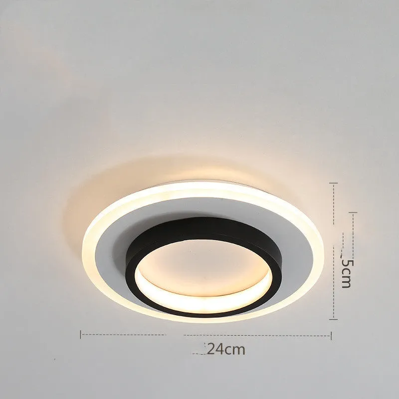 Black circular LED corridor light with aluminium and acrylic construction, 21cm diameter, for balcony or porch use