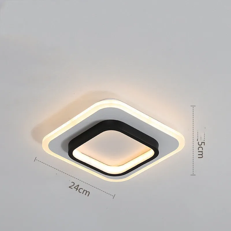 Black circular LED corridor light with aluminium and acrylic construction, 21cm diameter, for balcony or porch use