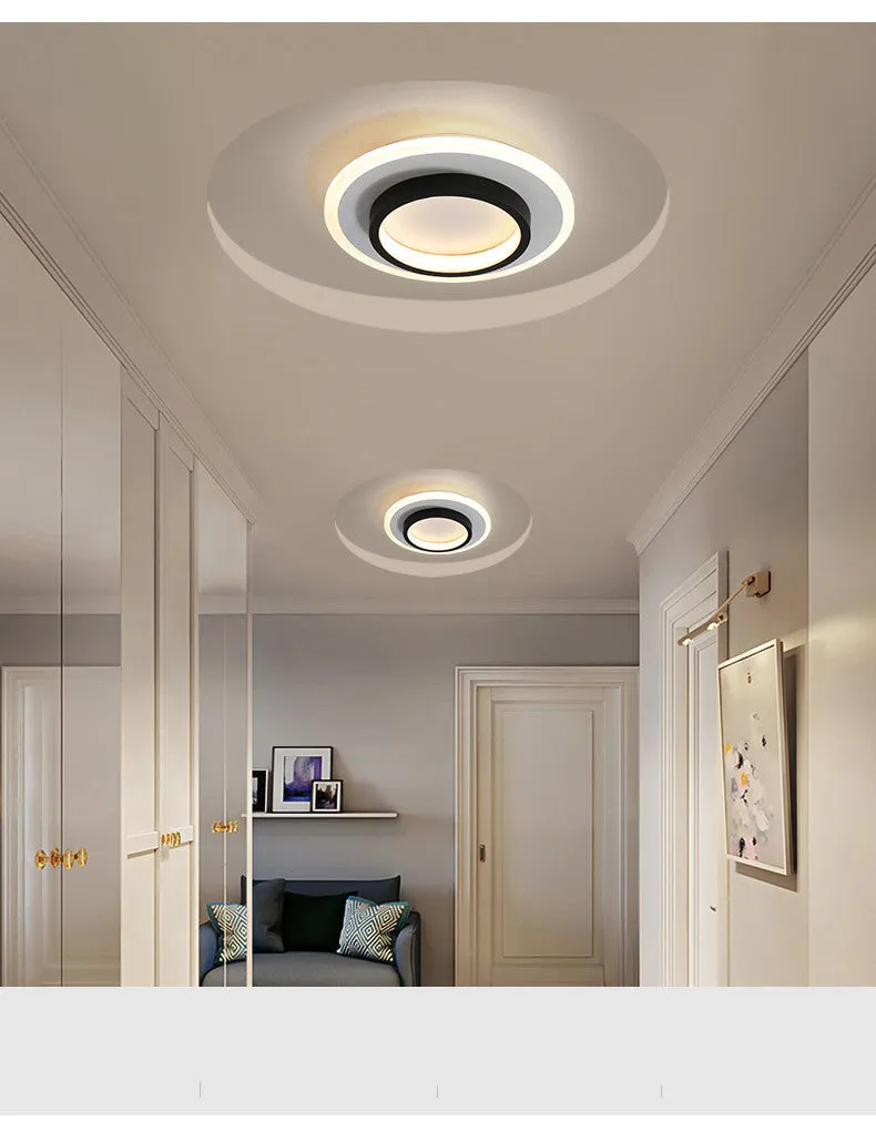 Black circular LED corridor light with aluminium and acrylic construction, 21cm diameter, for balcony or porch use