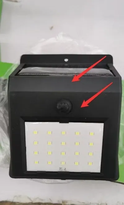 Solar sensor light with 20 LED beads and infrared sensor on a wall in outdoor setting