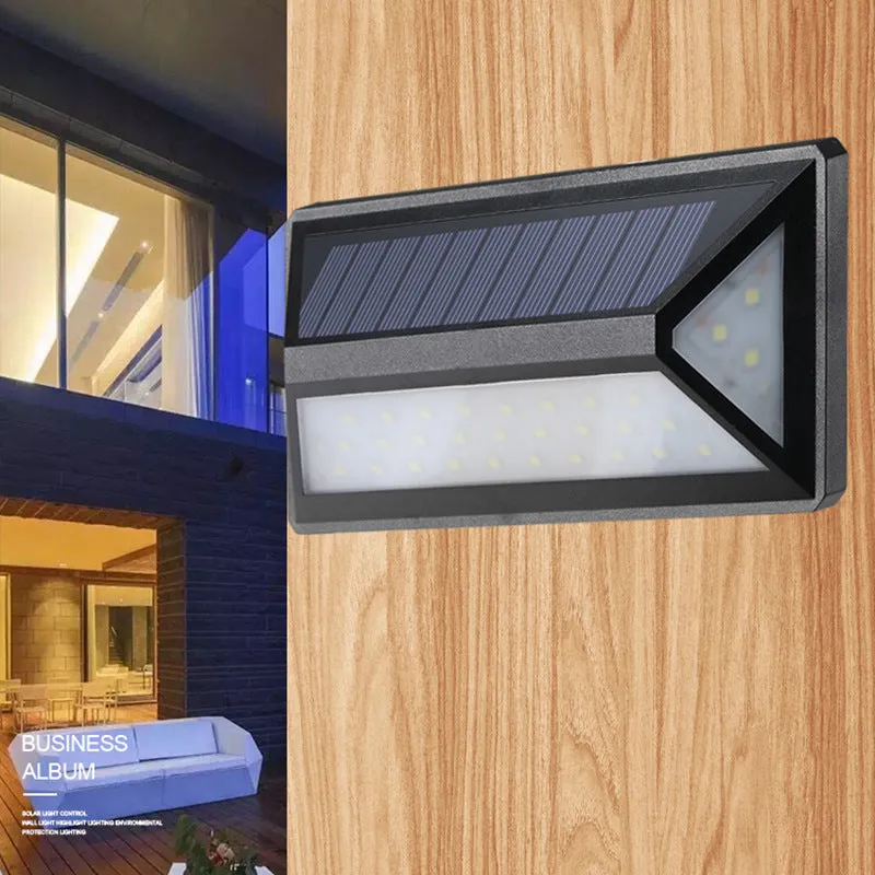 Black solar wall light with 33 LEDs, IP65 rated, measuring 166x75x30mm, mounted on an exterior wall