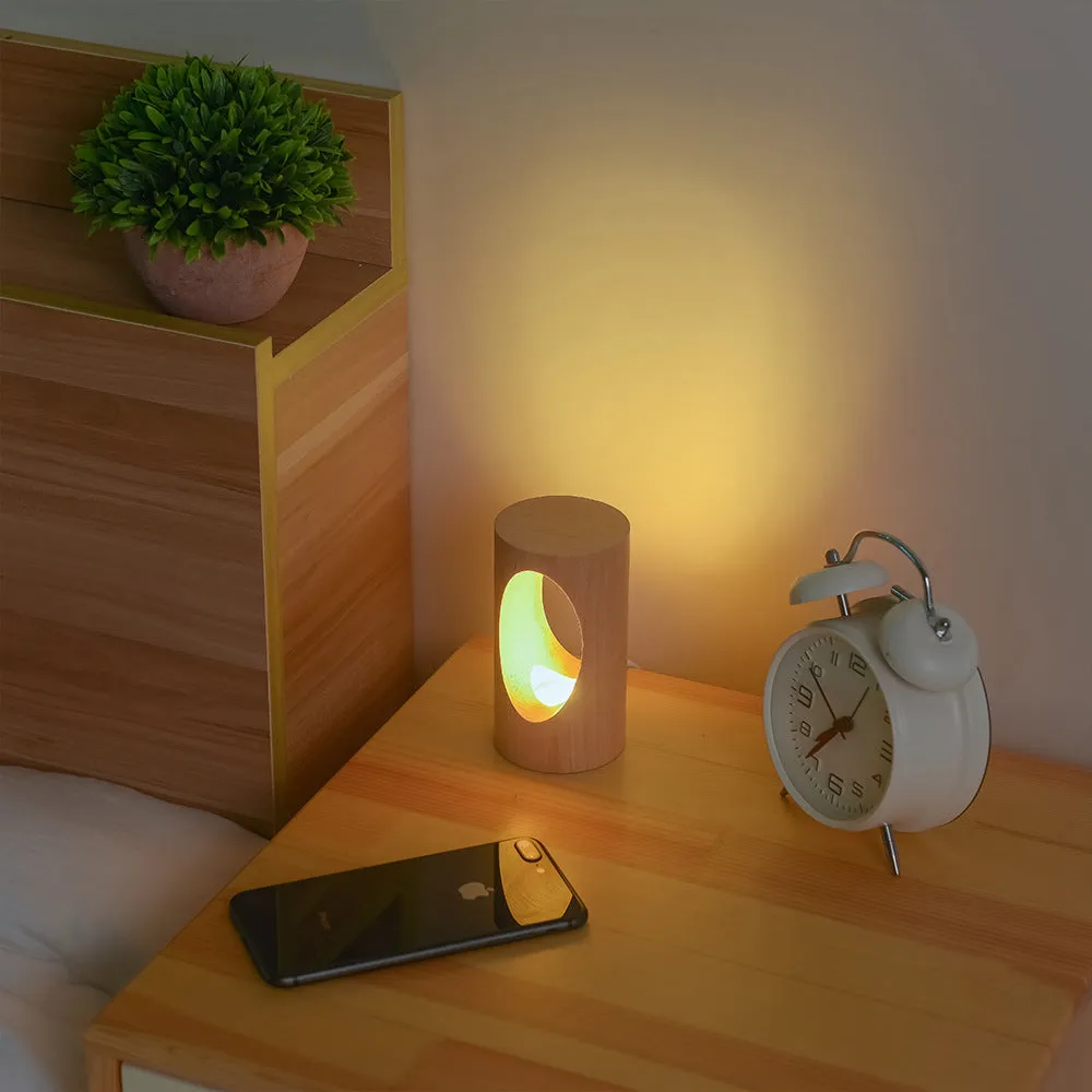Solid wood LED reading lamp with glass lampshade on a desk, USB cable visible