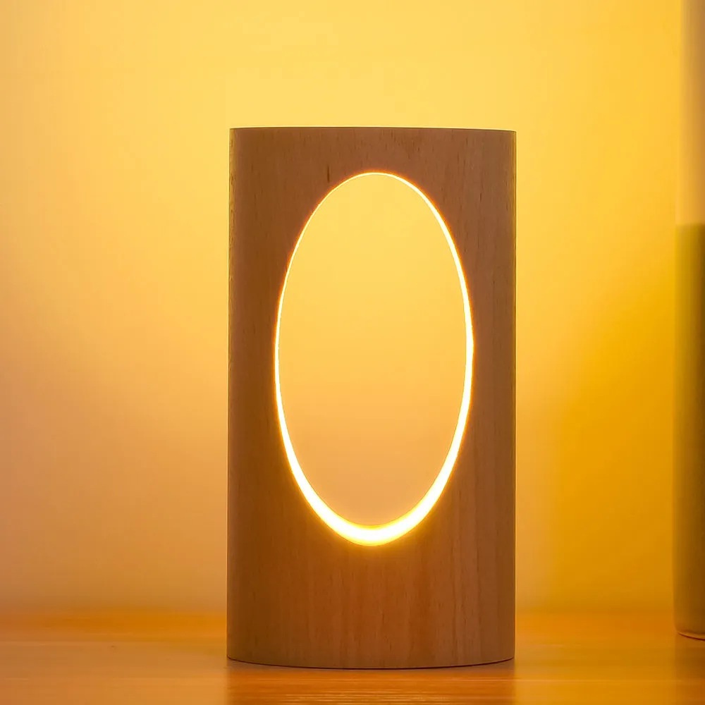 Solid wood LED reading lamp with glass lampshade on a desk, USB cable visible