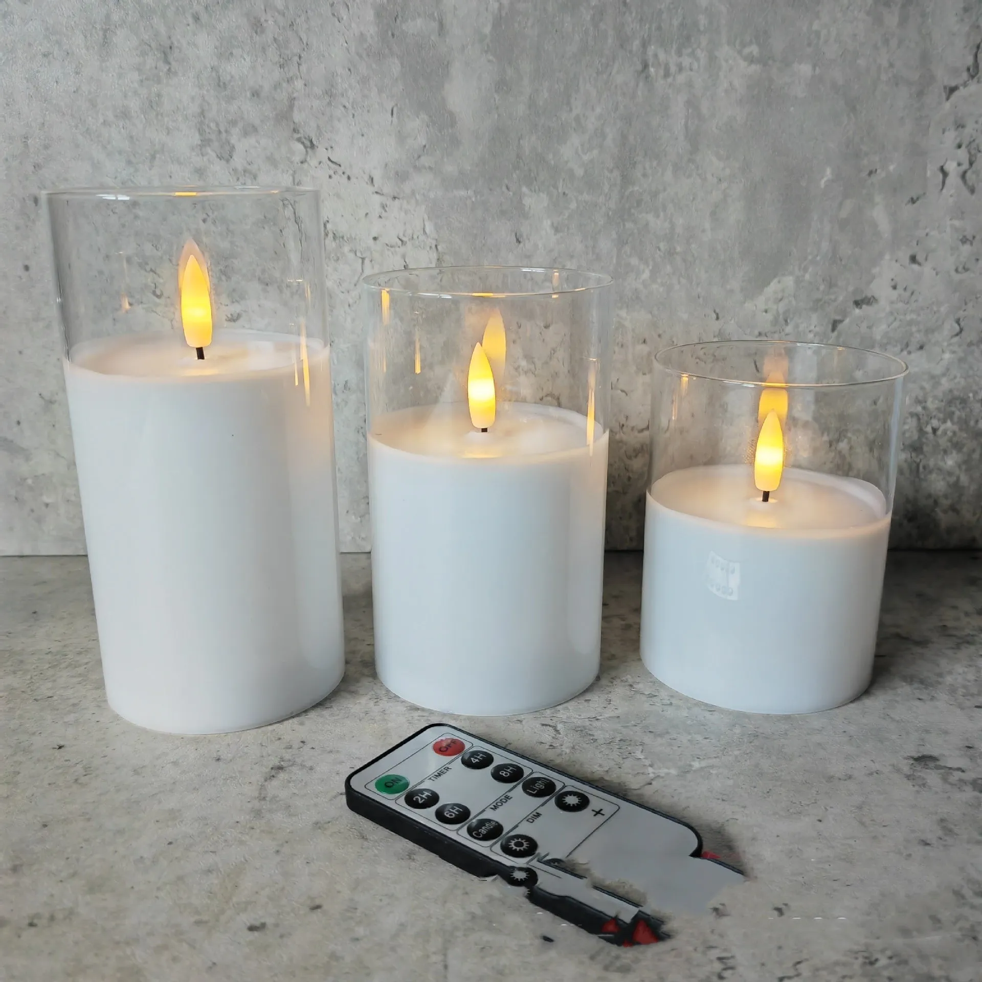 Set of three LED electronic candle lights in gold, gray, and white electroplated glass, sizes 7.5x10cm, 7.5x12.5cm, 7.5x15cm, with a remote control and USB cable.