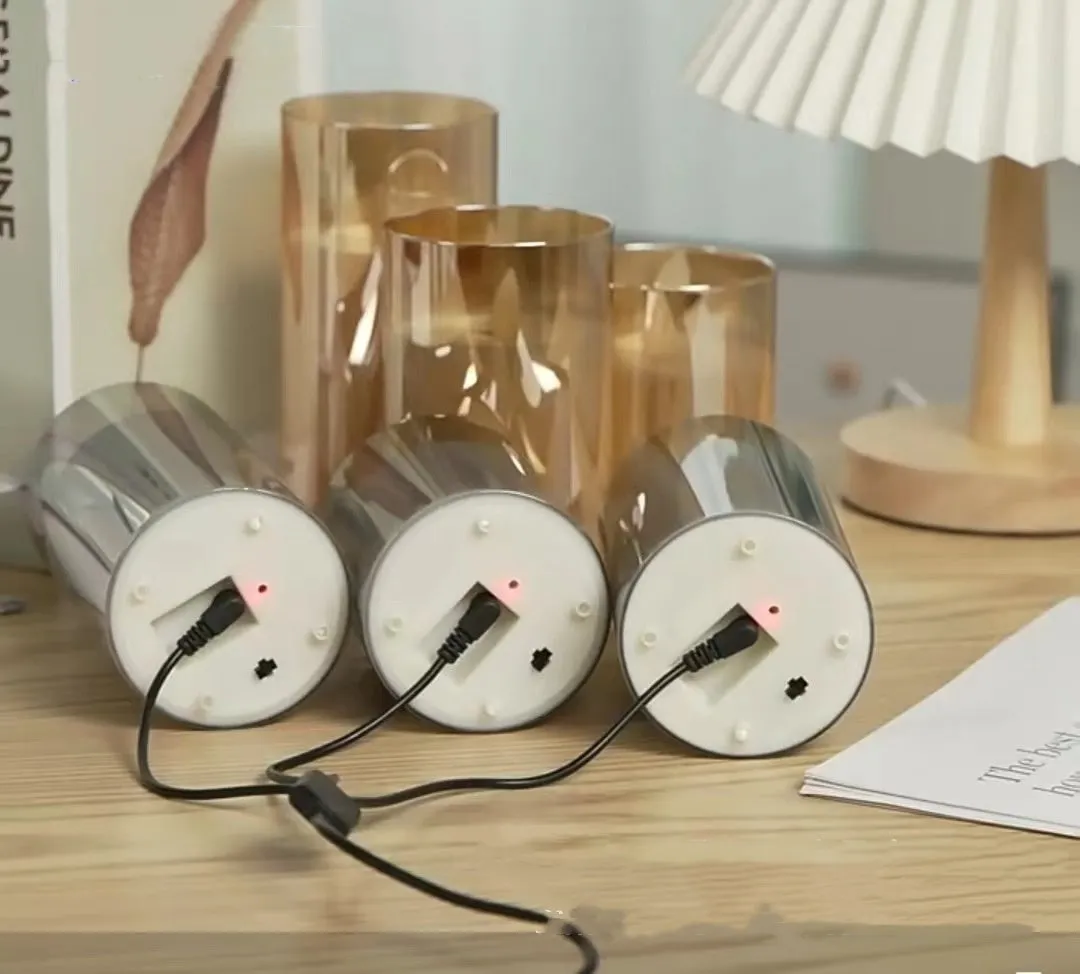 Set of three LED electronic candle lights in gold, gray, and white electroplated glass, sizes 7.5x10cm, 7.5x12.5cm, 7.5x15cm, with a remote control and USB cable.