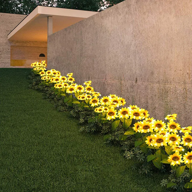 Set of LED solar sunflower garden lights with yellow Bujuan flower heads and stainless steel stems placed along a pathway