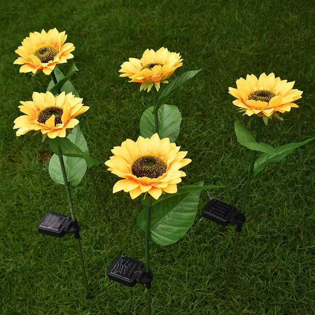 Set of LED solar sunflower garden lights with yellow Bujuan flower heads and stainless steel stems placed along a pathway