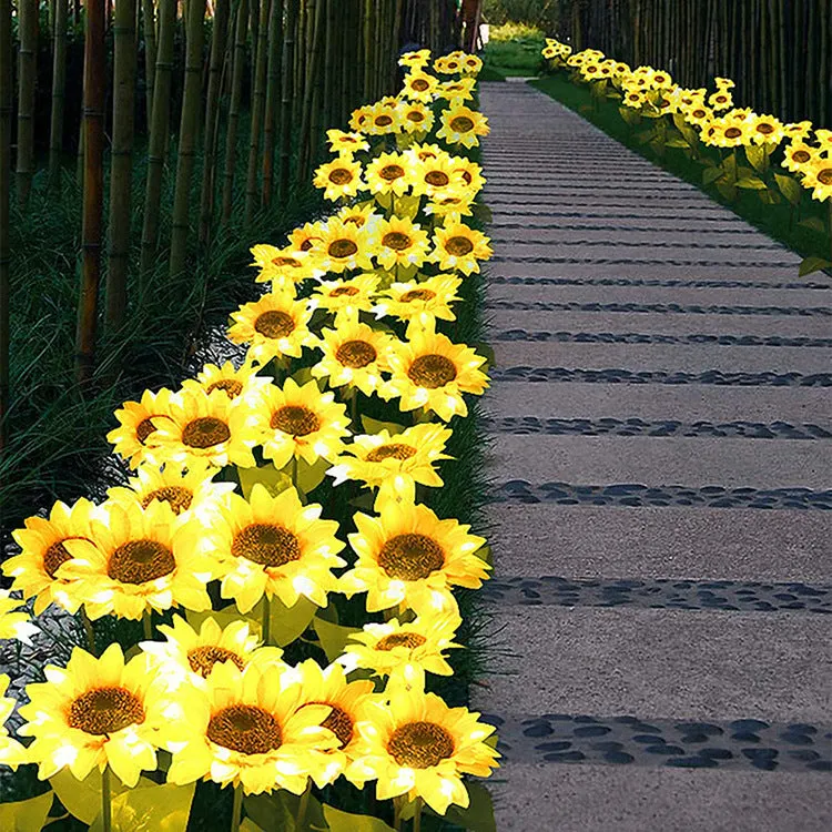 Set of LED solar sunflower garden lights with yellow Bujuan flower heads and stainless steel stems placed along a pathway