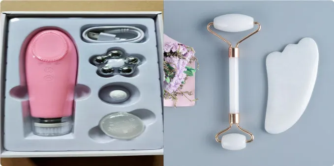 White jade facial roller with double heads and a matching gua sha scraping board on a plain surface.