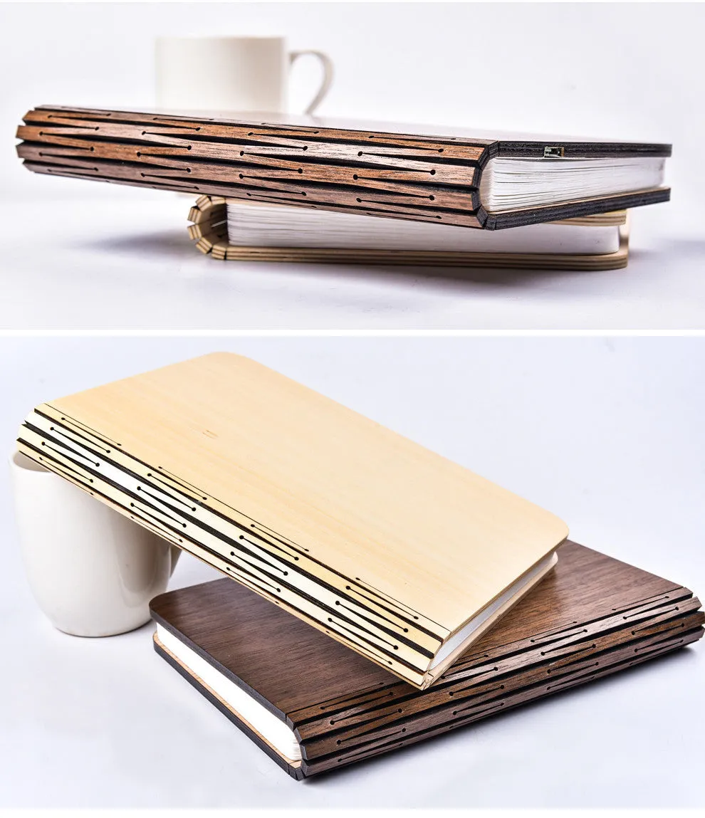 Walnut wooden book light open with colour changing LED pages on a desk