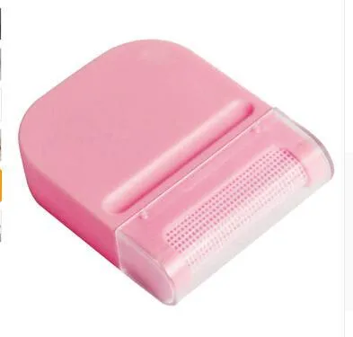 Manual fuzz remover brush with removable catching net for clothes and sofas, compact plastic design