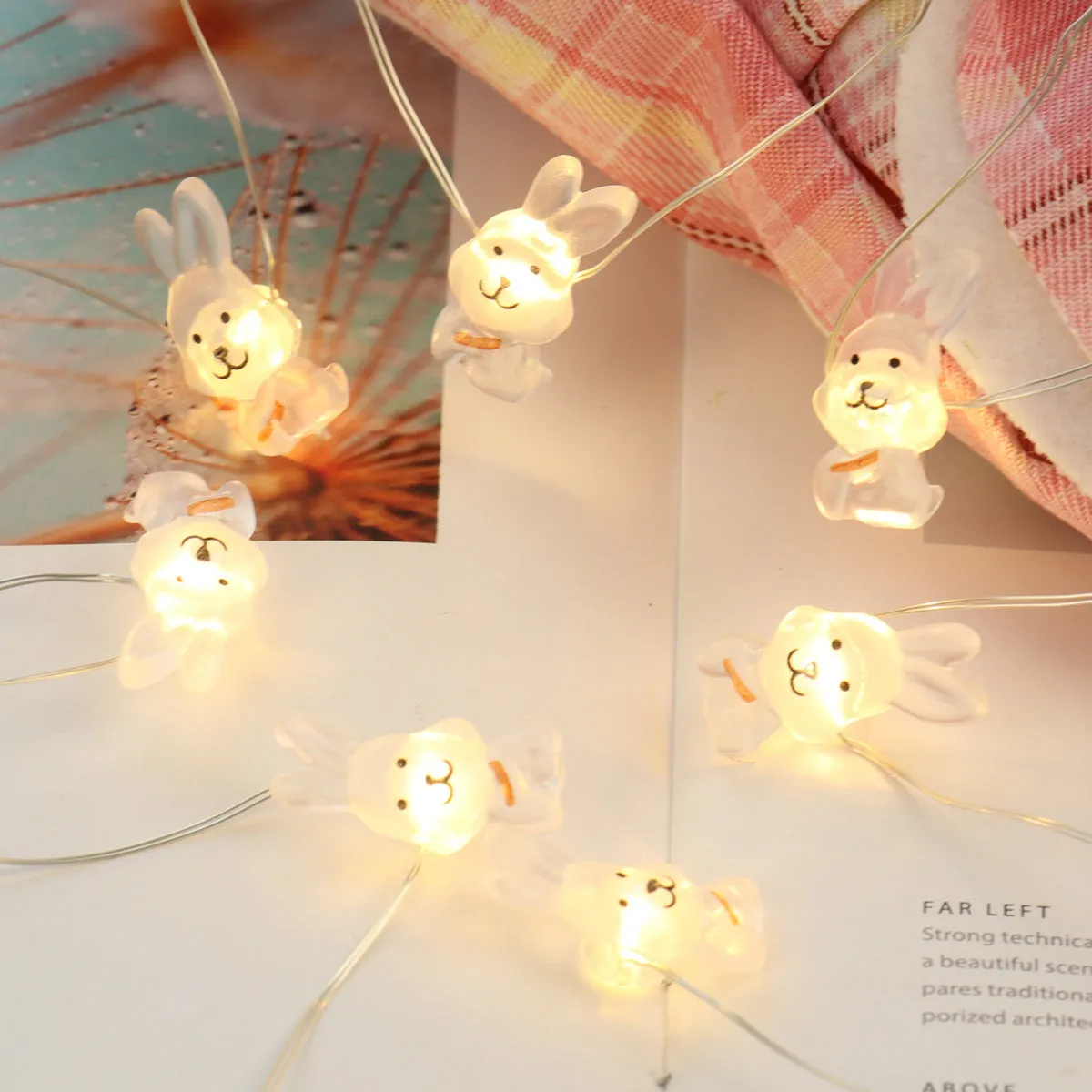 Easter LED bunny string lights with carrot and transparent white rabbit bulbs on a dark background