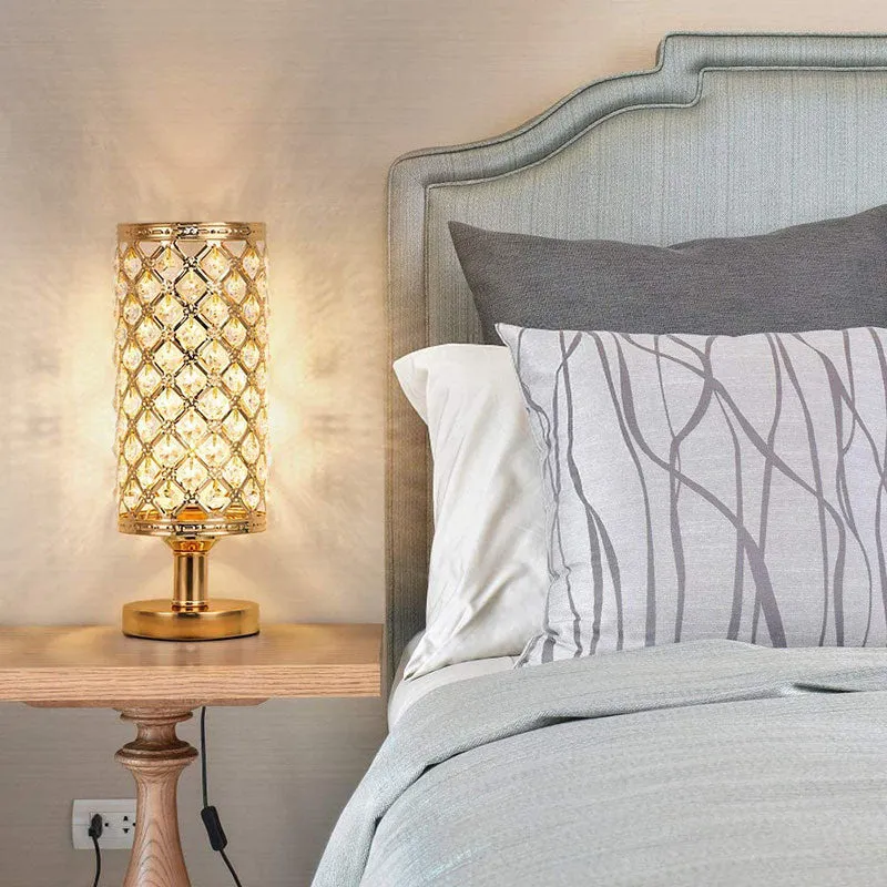 Modern crystal table lamp with hollow-carved design, metal base, gold finish, push button switch, on bedside table