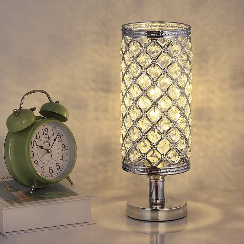 Modern crystal table lamp with hollow-carved design, metal base, gold finish, push button switch, on bedside table