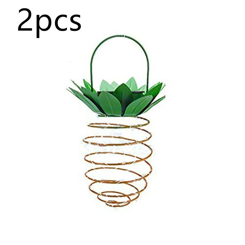 Outdoor waterproof green pineapple solar path light with 20 warm white LEDs and metal frame on a garden table