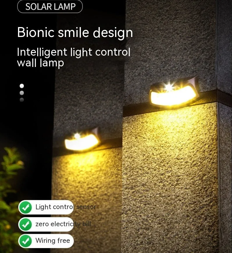 Solar outdoor wall light with smiling face design for garden decoration