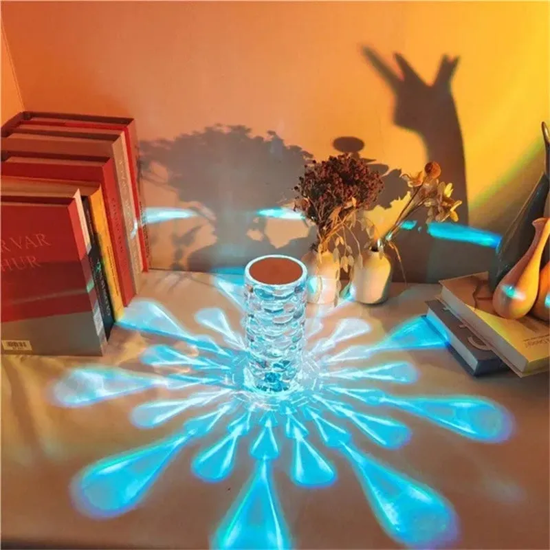 Crystal table lamp with teardrop acrylic shade showing droplet shadow effect on bedside table