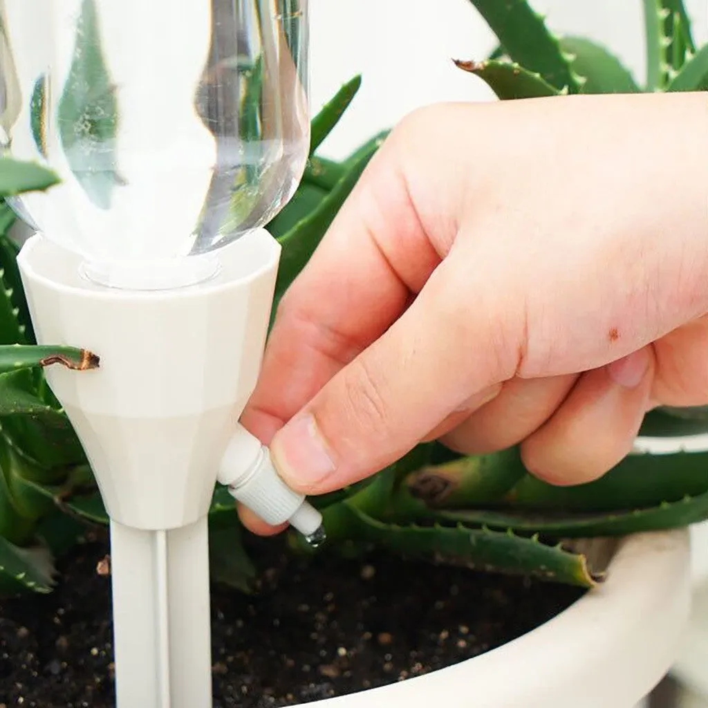 Automatic garden watering device in white, pink, and blue PP plastic, 16.5cm tall, for plant root watering