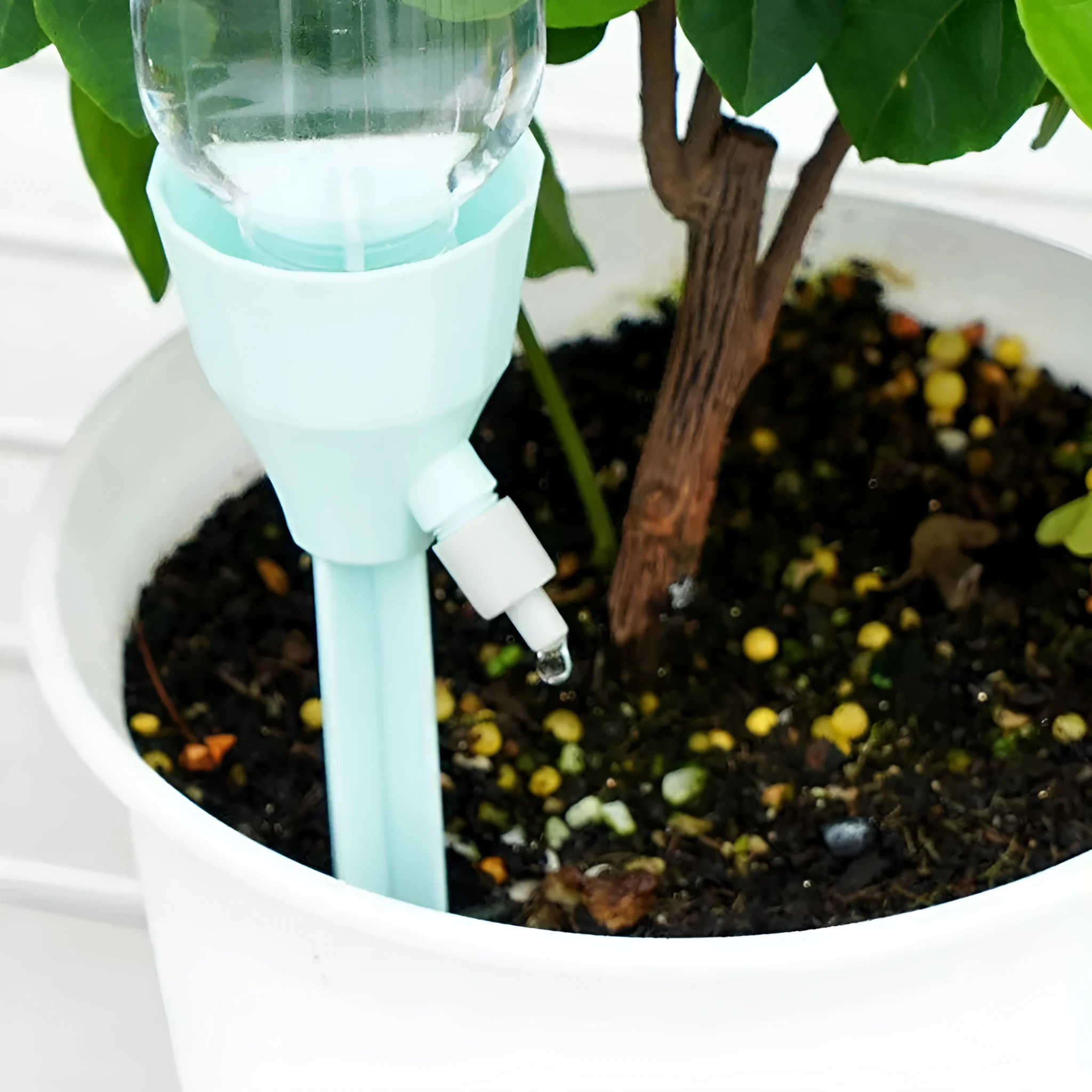 Automatic garden watering device in white, pink, and blue PP plastic, 16.5cm tall, for plant root watering