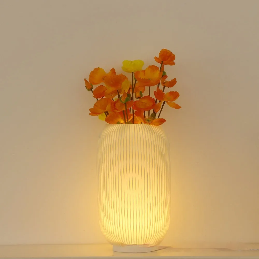 3D printed cylindrical vase night lamp in wood colour finish on a modern bedside table