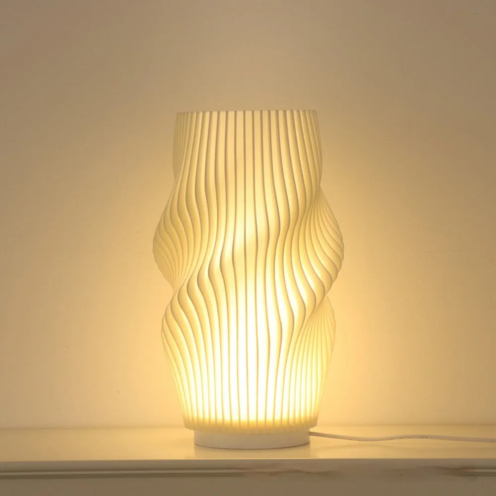 3D printed cylindrical vase night lamp in wood colour finish on a modern bedside table